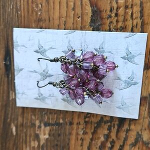 Antiqued metal with bubbled purple tinted size and shaped beads..Measures 2 inch